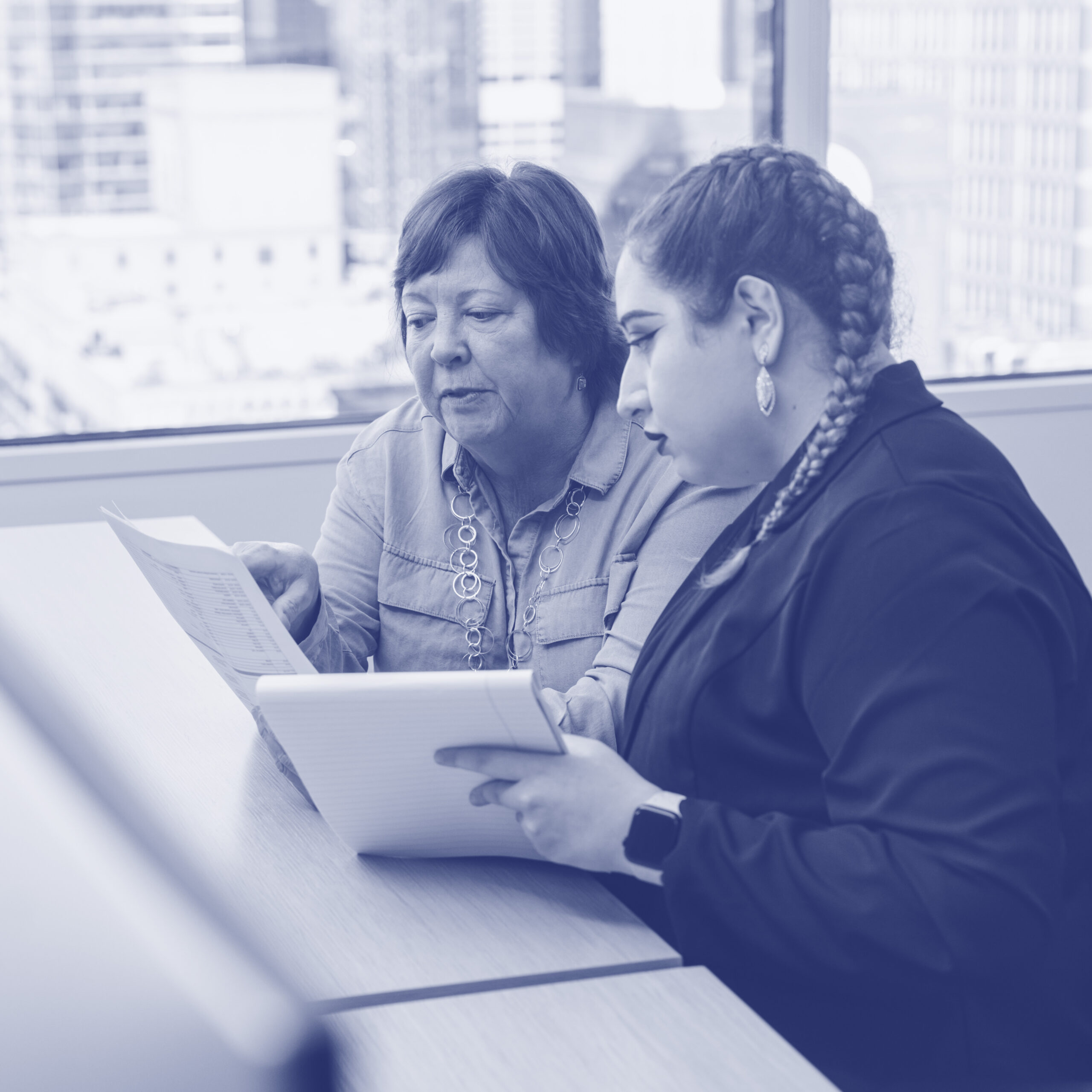 A Mentor and Mentee Work Together_navy Disabled mentor and mentee work together in a corporate office.