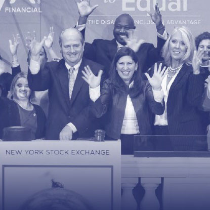 esg-crop Various people raising their hands at the New York Stock Exchange.